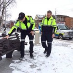 Canadian paramedics approach sculpture "Homeless Jesus"